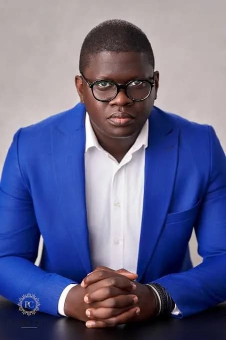 Portrait of Dr. Stephen Akintayo in a blue suit